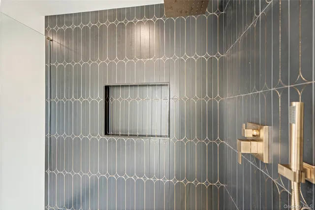 a bathroom with a double vanity sink a mirror and a bathtub