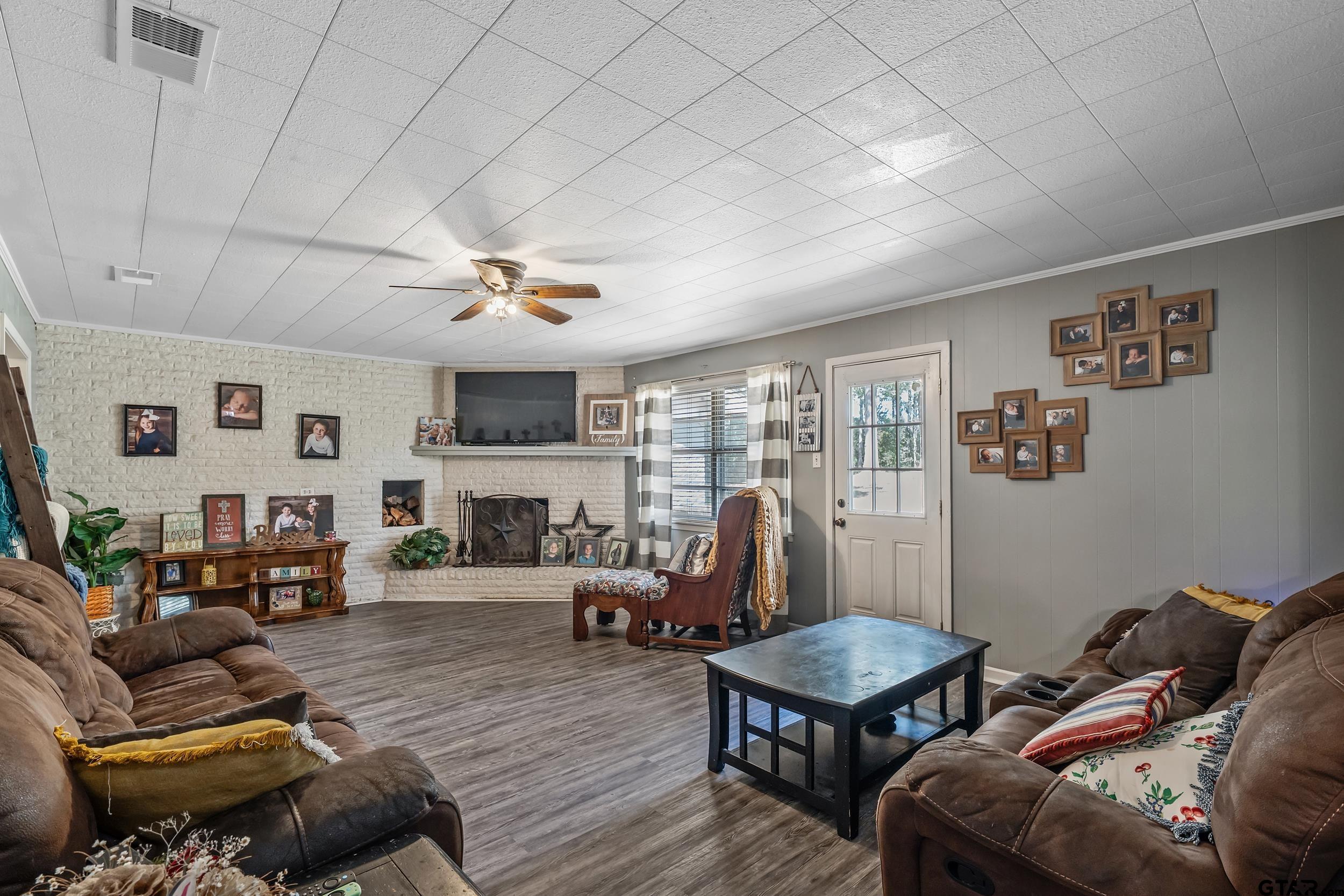271 Nottingham Rusk, TX 75785 - Photo 11 of 23 a living room with furniture flat screen tv and a large window
