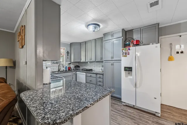 a kitchen with refrigerator and cabinets