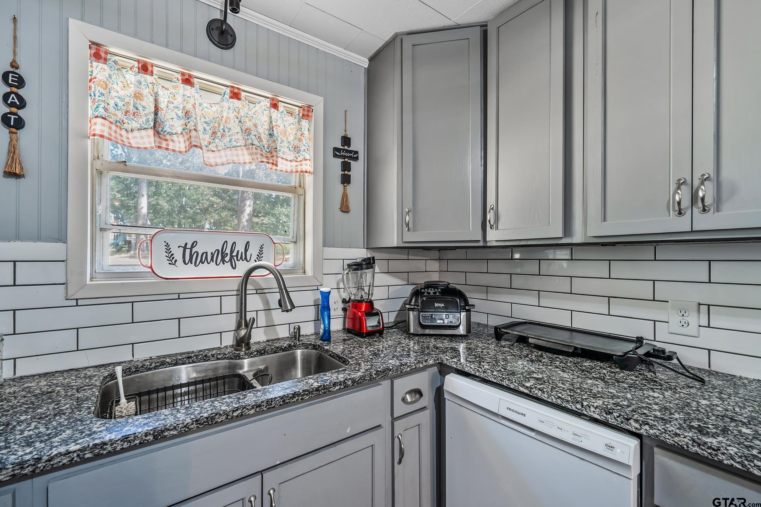 271 Nottingham Rusk, TX 75785 - Photo 6 of 23 a kitchen with stainless steel appliances granite countertop a sink a window and cabinets