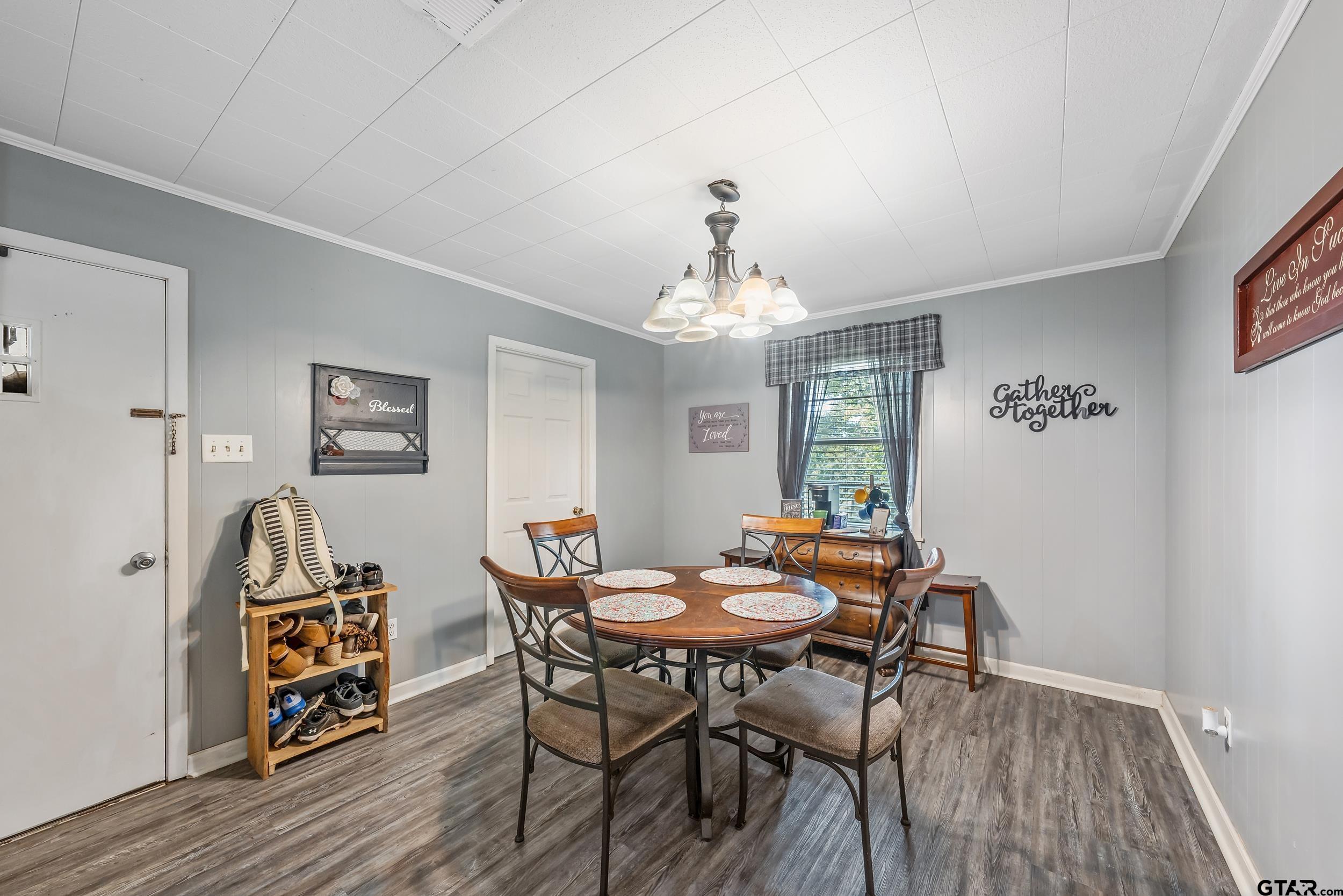 271 Nottingham Rusk, TX 75785 - Photo 7 of 23 a dining room with furniture a chandelier and wooden floor