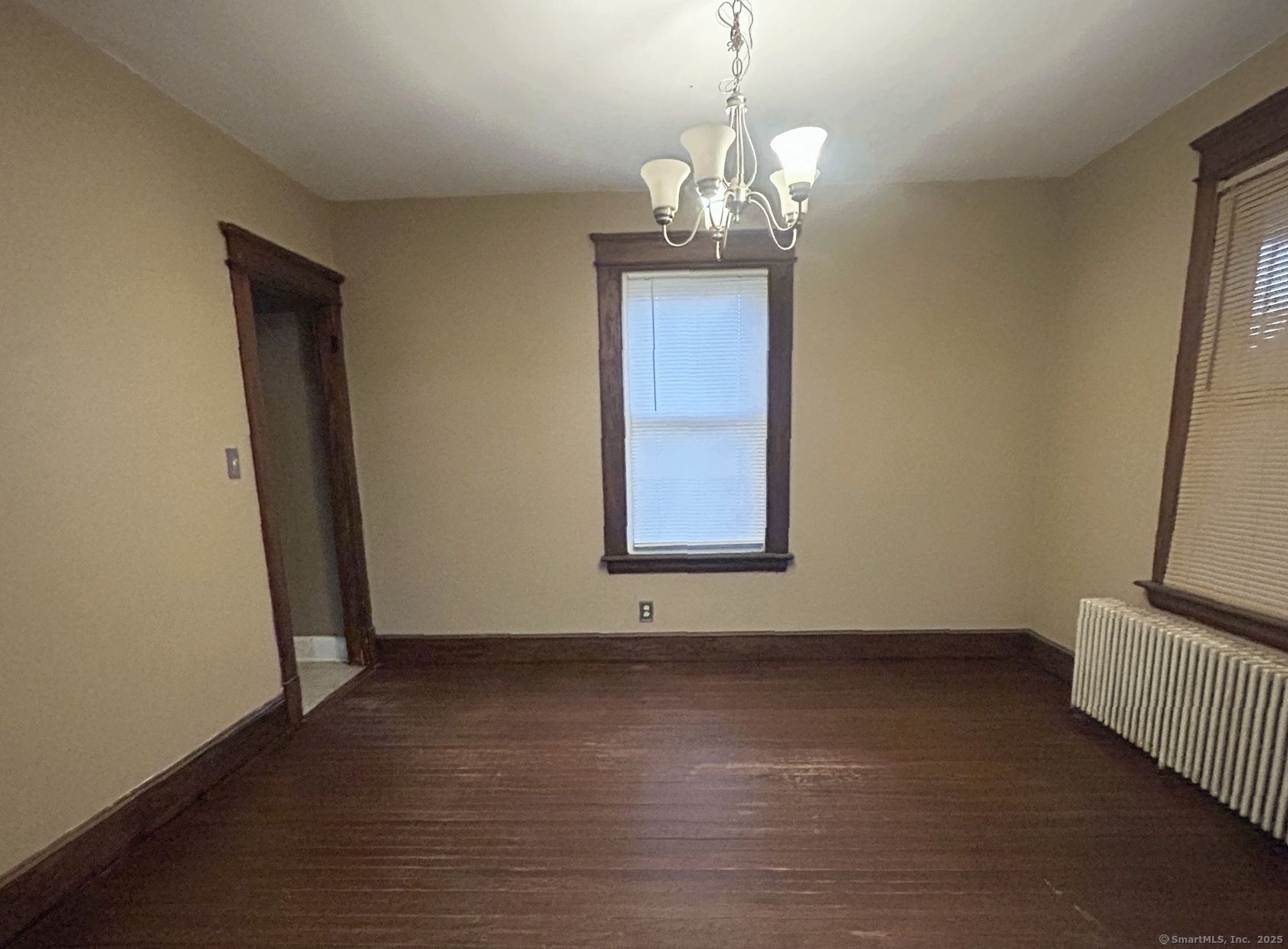 35 Hewey Street Waterbury, CT 06708 - Photo 6 of 14 a view of an empty room with wooden floor and a window