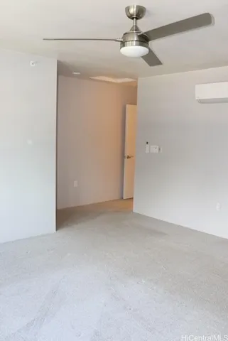 an empty room with a ceiling fan and a window