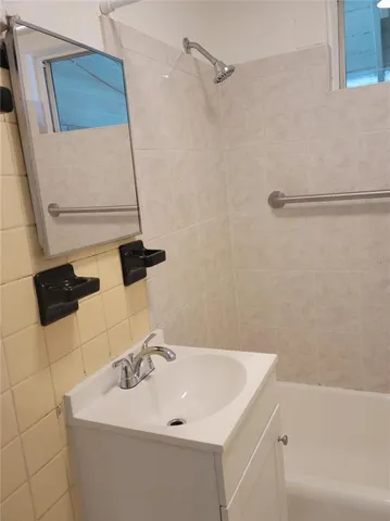 a bathroom with a sink a mirror and shower