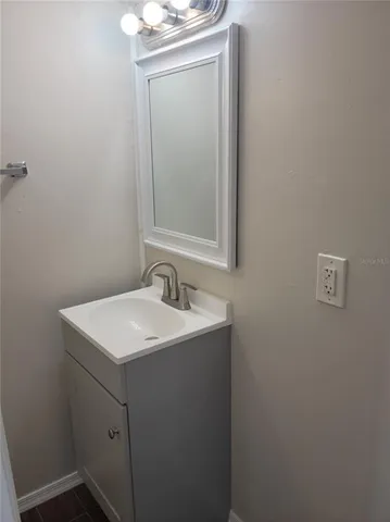 a bathroom with a sink a toilet and mirror