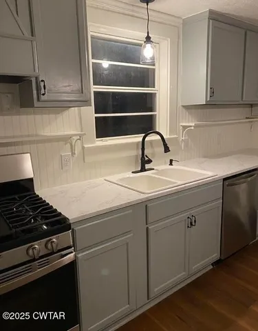 a kitchen with a sink and cabinets
