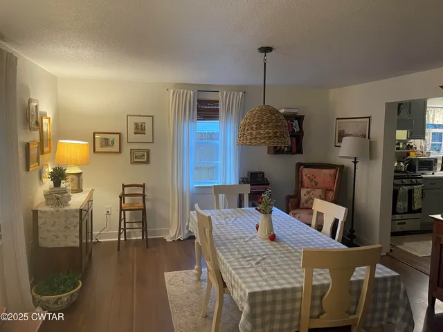 a dining room with furniture and wooden floor
