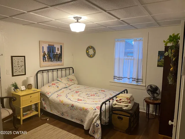 a bedroom with a bed and a table in it