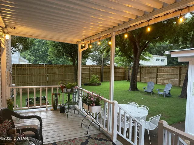 a view of a chair and tables in the backyard