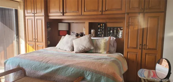 a large bed sitting in a bedroom next to a window