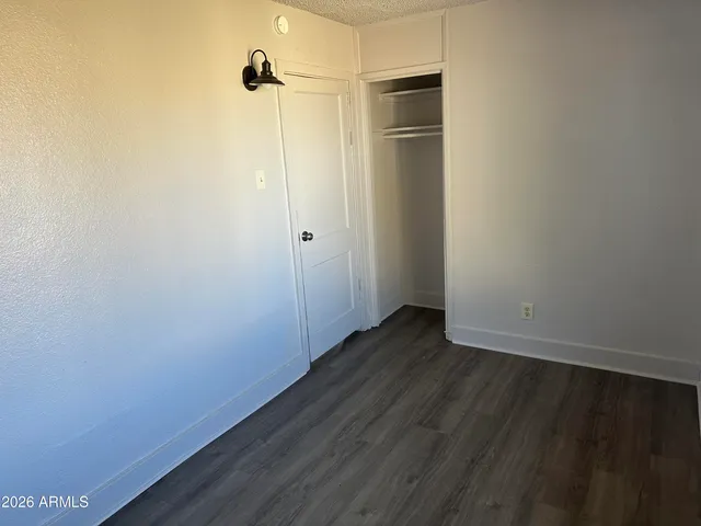 a view of a small space with wooden floor and a ceiling fan