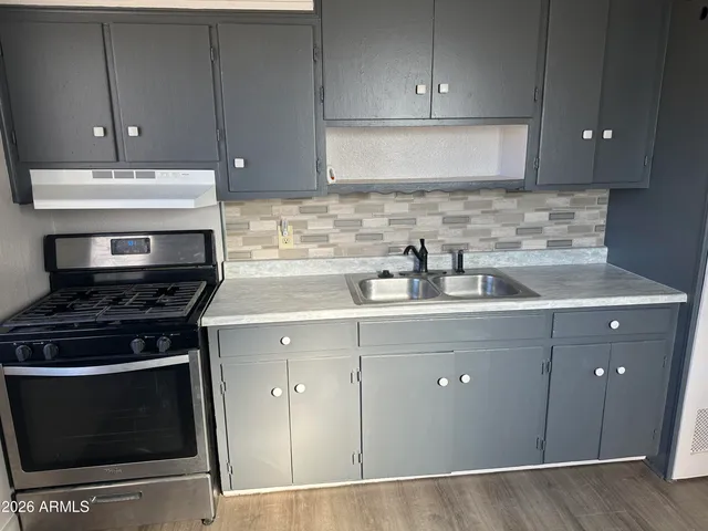 a kitchen with a stove and a sink