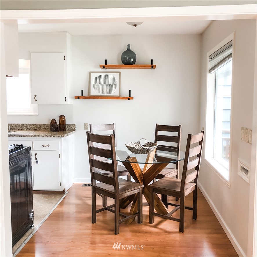 528 North 74th Street Seattle, WA 98103 - Photo 12 of 34 a view of a dining room with furniture and wooden floor