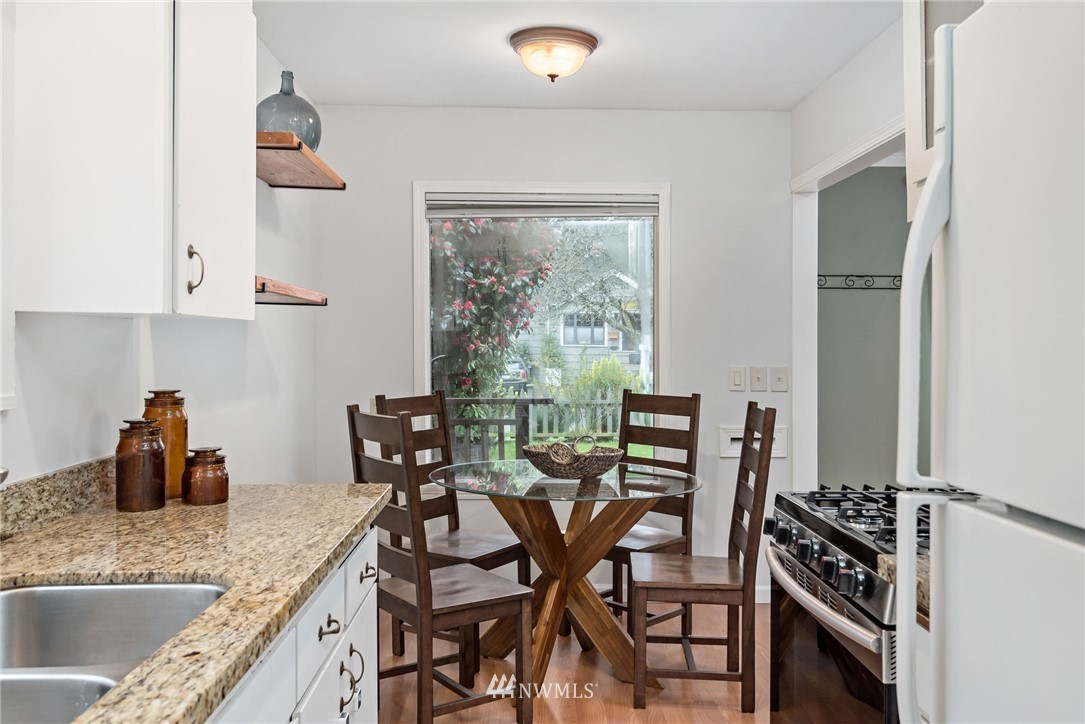 528 North 74th Street Seattle, WA 98103 - Photo 17 of 34 a kitchen with a table chairs and a stove