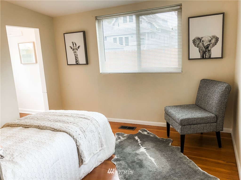 528 North 74th Street Seattle, WA 98103 - Photo 21 of 34 a bedroom with a bed and a chair