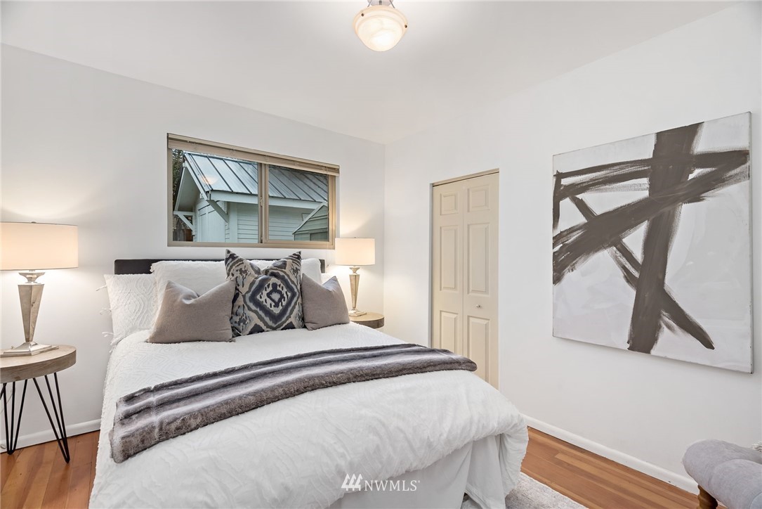 528 North 74th Street Seattle, WA 98103 - Photo 25 of 34 a bedroom with a bed and wooden floor