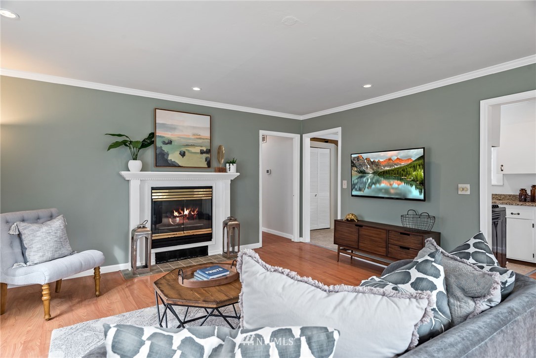 528 North 74th Street Seattle, WA 98103 - Photo 10 of 34 a bedroom with furniture and a fireplace