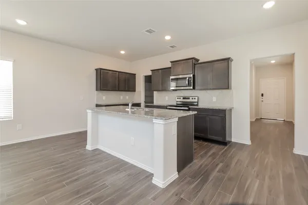 a kitchen with a sink cabinets and stainless steel appliances