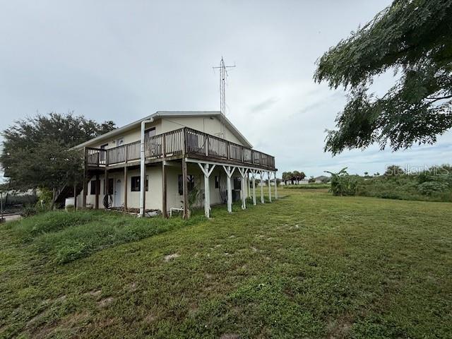 a view of a house with a big yard and large trees