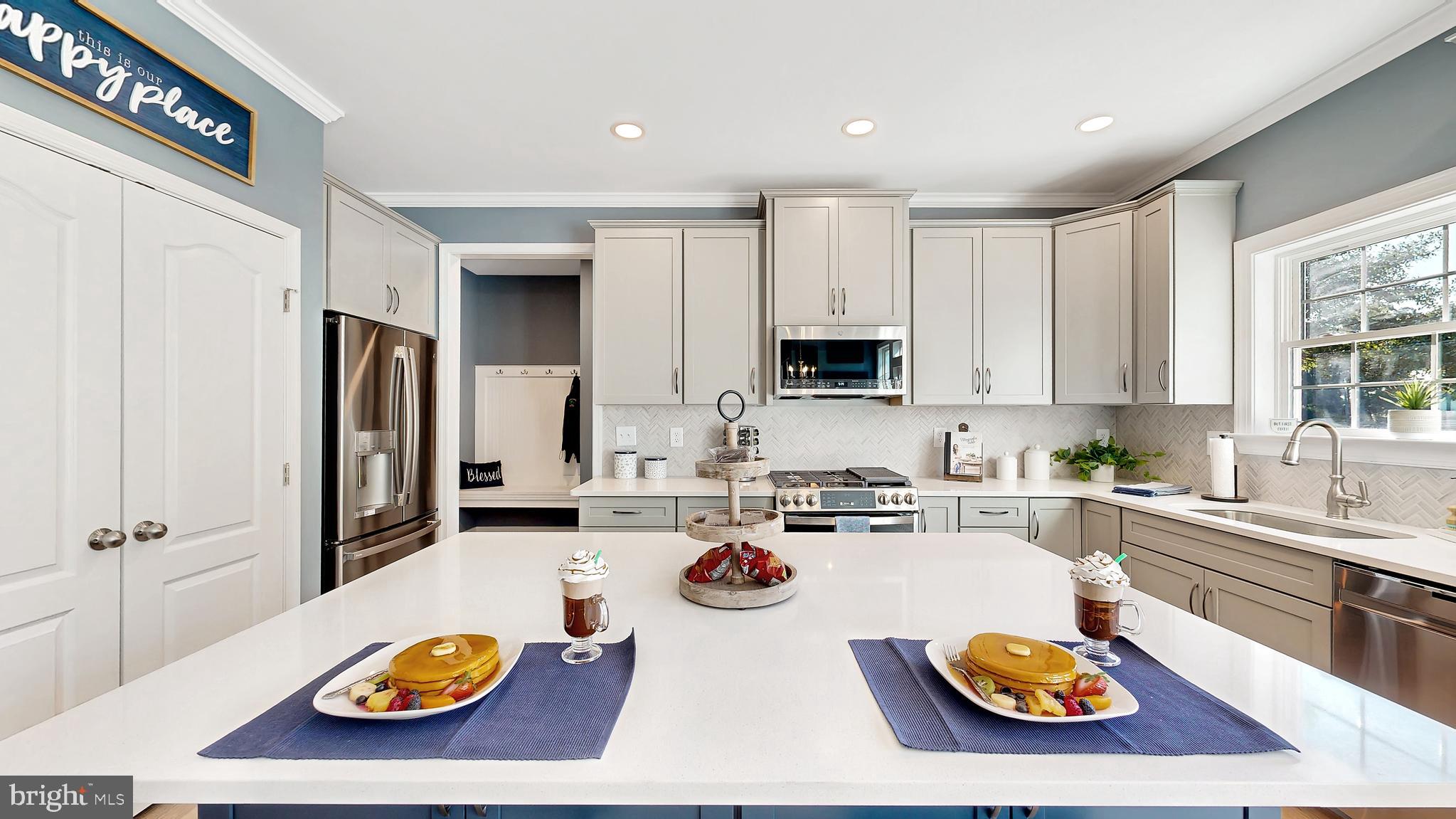 8 Antlered Way Georgetown, DE 19947 - Photo 3 of 19 a kitchen with a table chairs stove and microwave