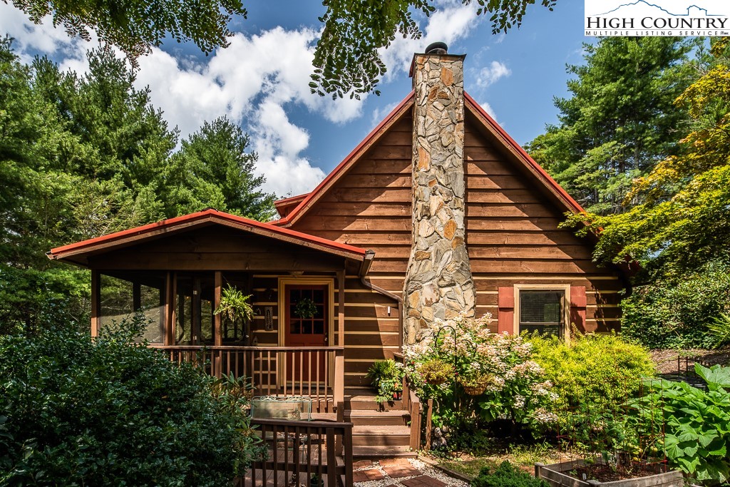 a front view of house with yard and trees