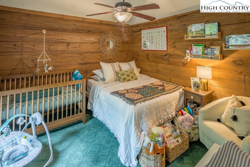 166 Mountain Ivy Lane Boone, NC 28607 - Photo 12 of 23 a bedroom with a bed and a baby crib