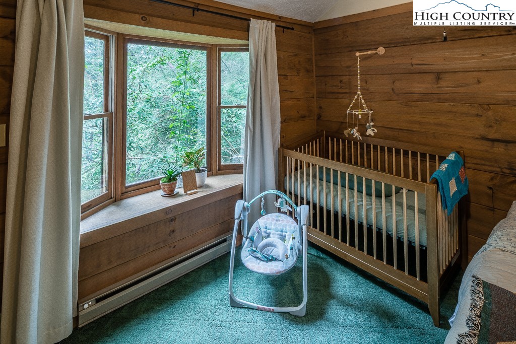 166 Mountain Ivy Lane Boone, NC 28607 - Photo 13 of 23 a bedroom with a bed and a window