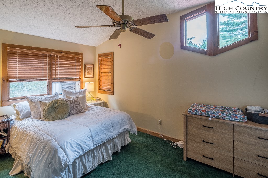 166 Mountain Ivy Lane Boone, NC 28607 - Photo 14 of 23 a bedroom with a bed and a window