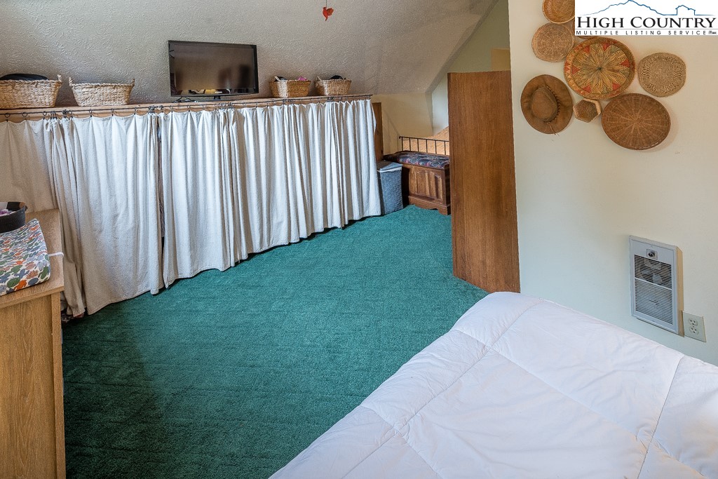 166 Mountain Ivy Lane Boone, NC 28607 - Photo 16 of 23 a bedroom with a bed and a window