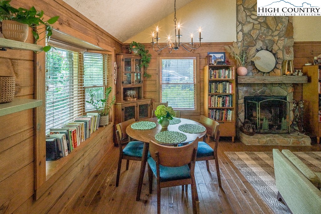 166 Mountain Ivy Lane Boone, NC 28607 - Photo 6 of 23 a dining room with furniture a fireplace and wooden floor
