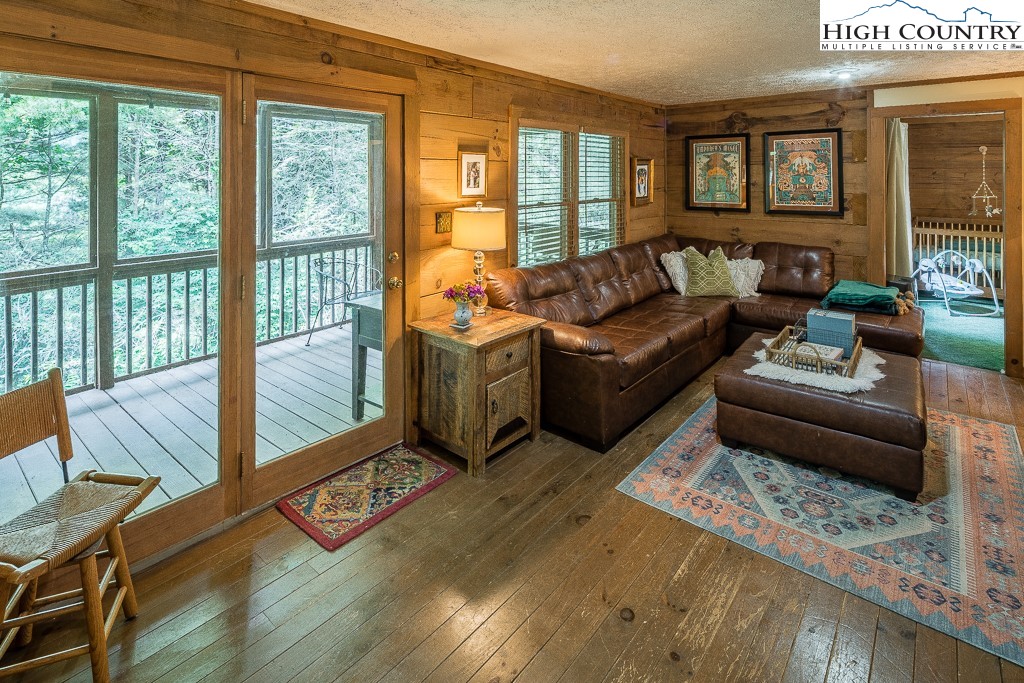166 Mountain Ivy Lane Boone, NC 28607 - Photo 10 of 23 a living room with furniture and a floor to ceiling window