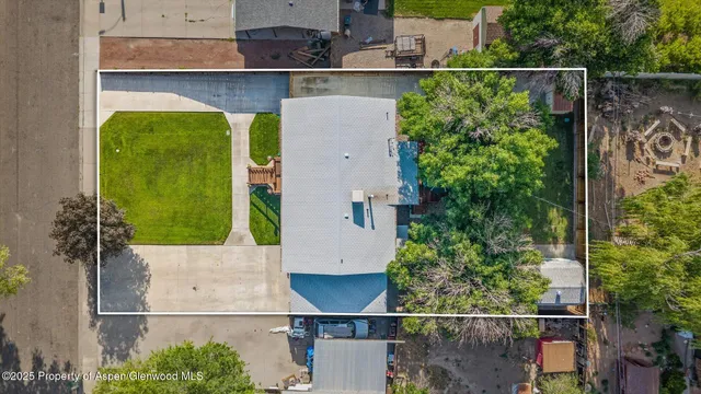 an aerial view of a house with a yard