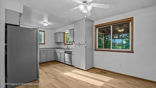 a view of a kitchen with a sink dishwasher and a refrigerator