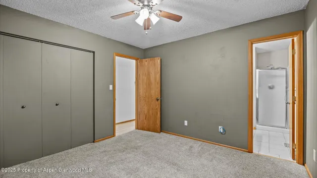 a view of a livingroom with a chandelier fan