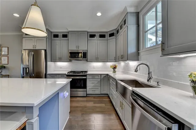 a kitchen with stainless steel appliances granite countertop a sink stove and refrigerator