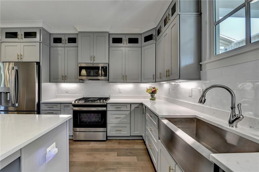 6065 Cushing Circle Norcross, GA 30071 - Photo 20 of 44 a kitchen with stainless steel appliances granite countertop a stove a sink and a microwave