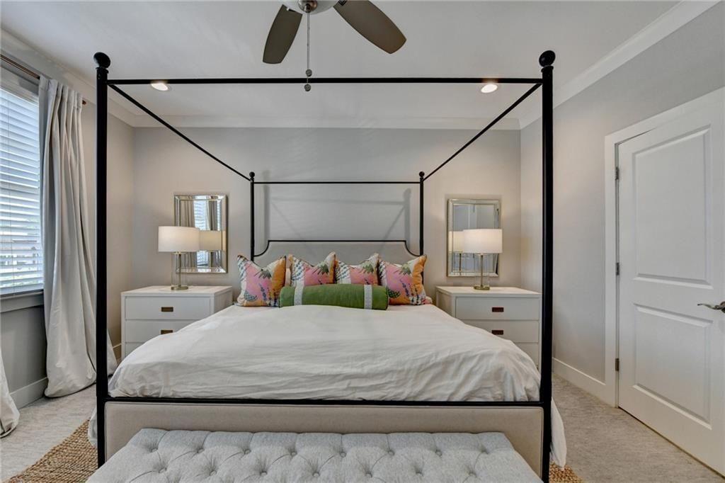 6065 Cushing Circle Norcross, GA 30071 - Photo 25 of 44 a bedroom with a large bed and a chandelier