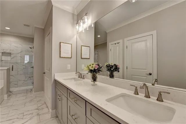 a bathroom with a sink double vanity and a shower