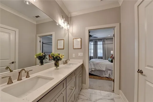 a en suite bathroom with double vanity sinks and a mirror