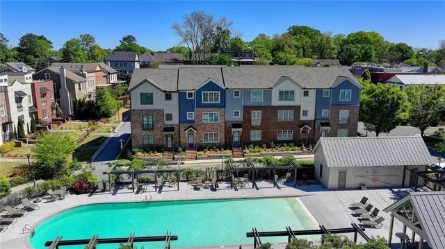 a view of a patio with table and chairs potted plants and large tree