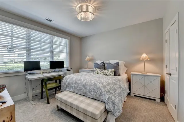 a bedroom with a bed and a desk