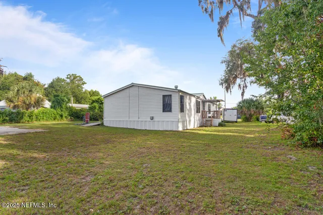 a view of a room with wooden floor closet and windows