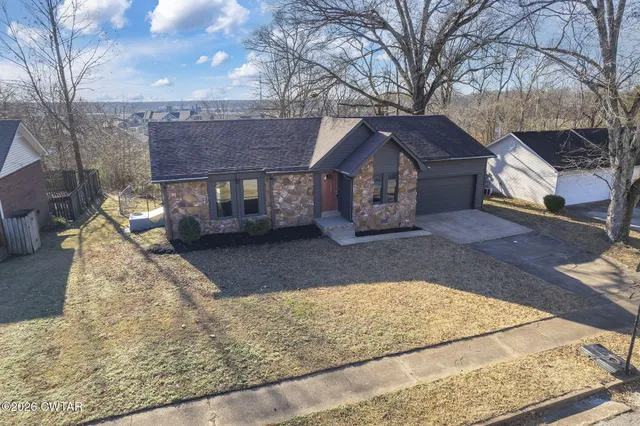 a view of a house with a snow in the yard