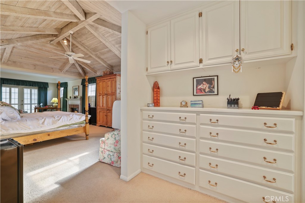 14015 Roblar Road Sherman Oaks, CA 91423 - Photo 20 of 35 a bedroom with a dresser and a chandelier