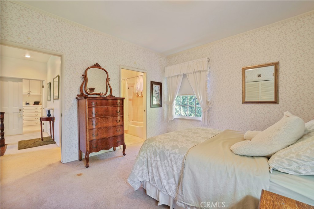 14015 Roblar Road Sherman Oaks, CA 91423 - Photo 24 of 35 a bedroom with a bed and a chandelier