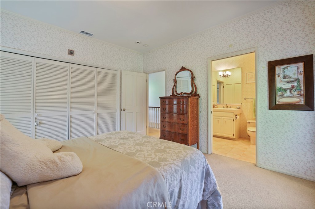 14015 Roblar Road Sherman Oaks, CA 91423 - Photo 25 of 35 a bedroom with a bed and a chandelier