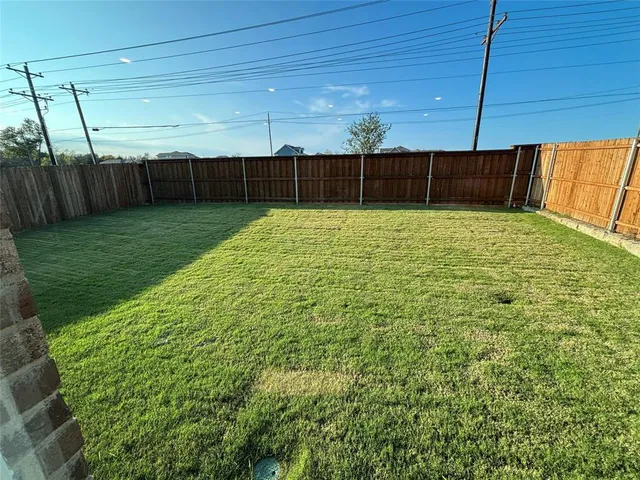 a view of yard with wooden fence