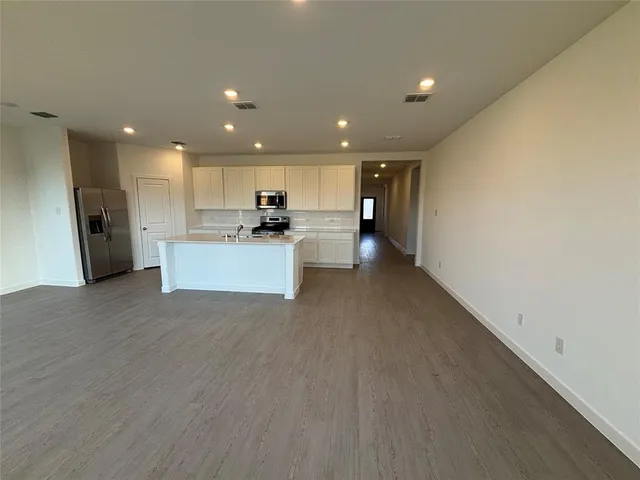 a view of a kitchen with a sink and a refrigerator