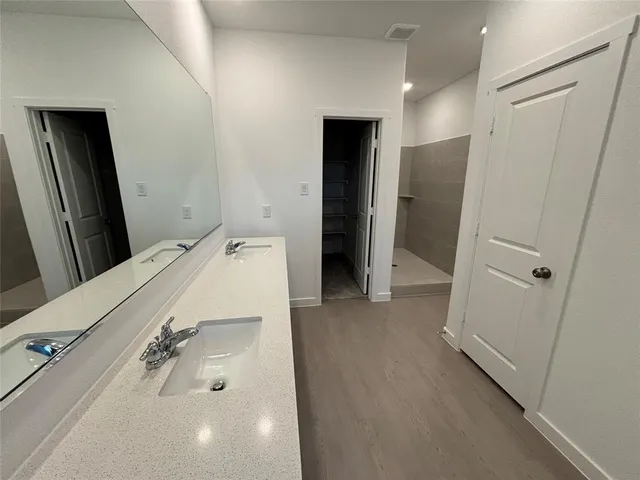 a bathroom with a tub sink and mirror