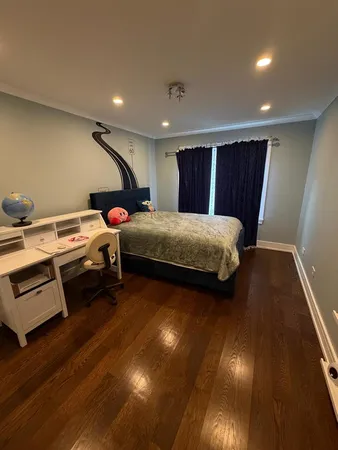 a bedroom with two beds and a desk